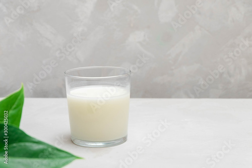 Plain ayran (kefir) fermented dairy drink on grey neutral background.