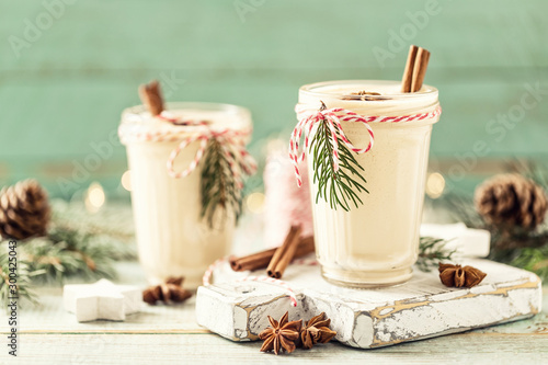 Eggnog. Traditional Christmas drink, spiced egg-milk cocktail with nut topping.