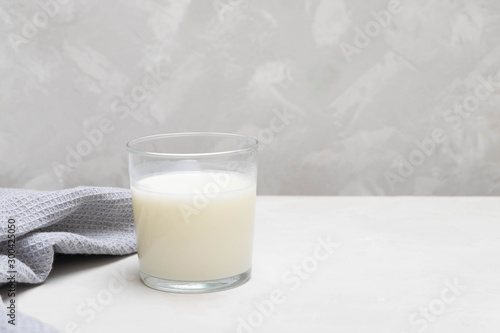 Yogurt-based beverage ayran (kefir) on grey concrete background.