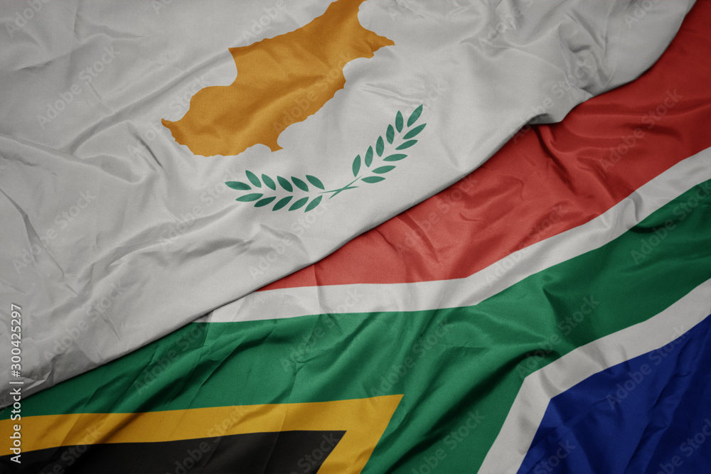 waving colorful flag of south africa and national flag of cyprus. waving colorful flag of south africa and national flag of cyprus.
