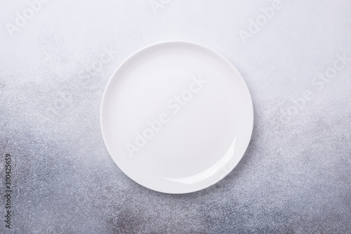 Empty white plate on stone background Copy space Top view - Image