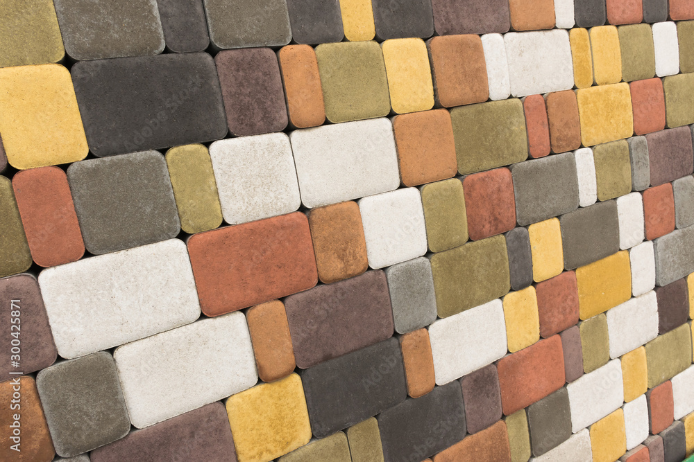 Paving slabs, stones of rectangular and square shapes of different colors laid out with patterns for equipping paths in the country as a background or texture Paving slabs, stones of rectangular and square shapes of different colors laid out with patterns for equipping paths in the country as a background or texture