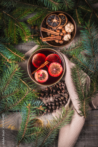 Fruit tea with cinnamon and lemon and decorations on a wooden background