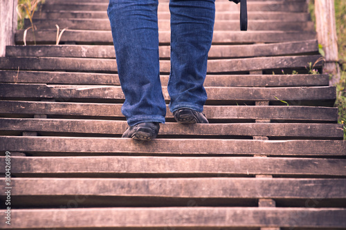 man climbing a wooden stairs