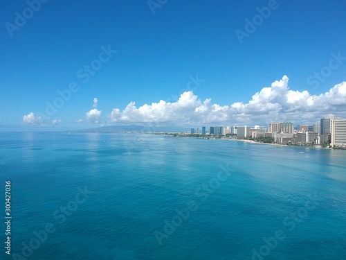 Panorama drone aerial view of Waikiki  beach Honolulu Hawaii USA turquoise waters white golden sandy beach resorts along the shore  © Elias Bitar
