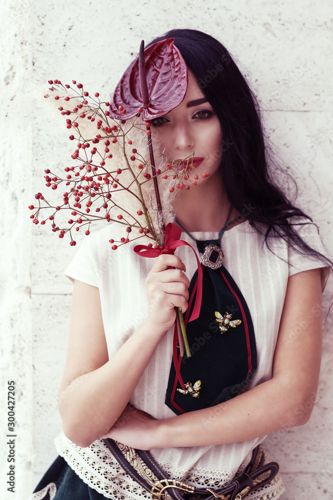 Fototapeta premium Outdoor portrait of a young glamorous fashionable woman posing on the street.