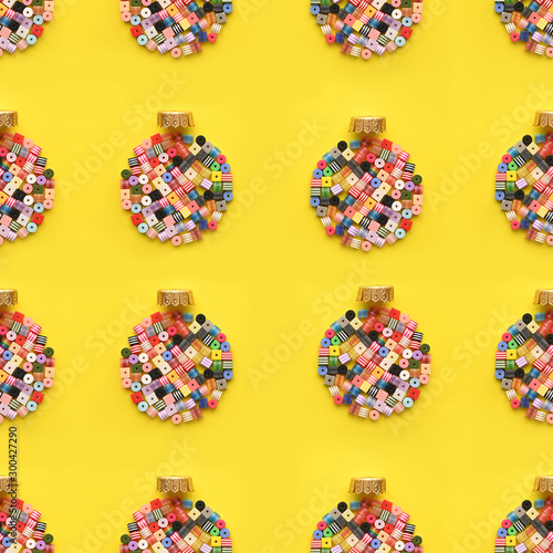 Christmas Bauble made of decoration elements on yellow background. Flat lay. Contemporary design. Contemporary art. Creative conceptual and colorful collage.