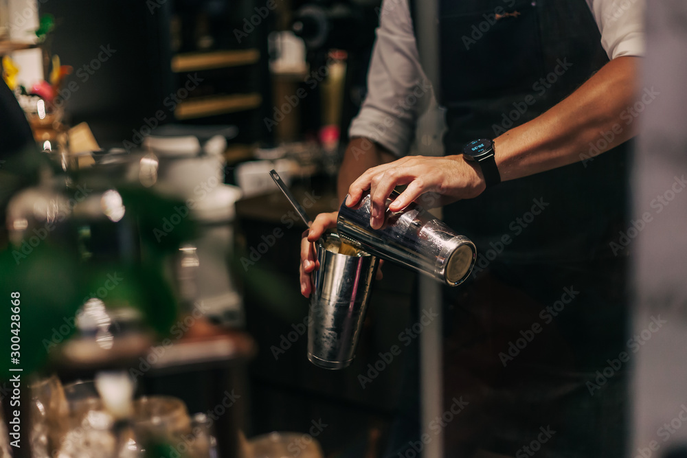 Bartender making cocktails at the bar, alcoholic drinks  