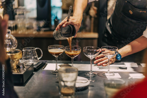 Bartender making cocktails at the bar, alcoholic drinks 