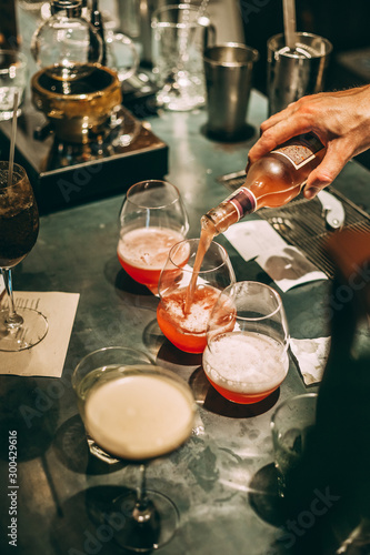 Bartender making cocktails at the bar, alcoholic drinks 