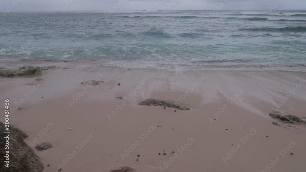 Beautiful rocky and sandy ocean coast on Bali island with clouds view. Horizon sky and waves. Beautiful rocky and sandy ocean coast on Bali island with clouds view. Horizon sky and waves.