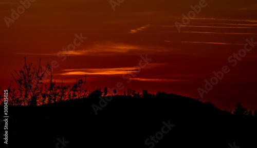Red orange sunset with hills in autumn dark evening © luzkovyvagon.cz