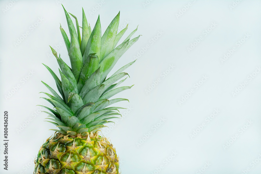 Fototapeta premium Fresh tropical pineapple isolated on a white background. Space for text.