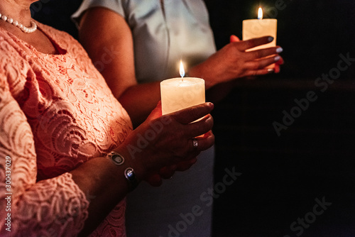 people hold candles