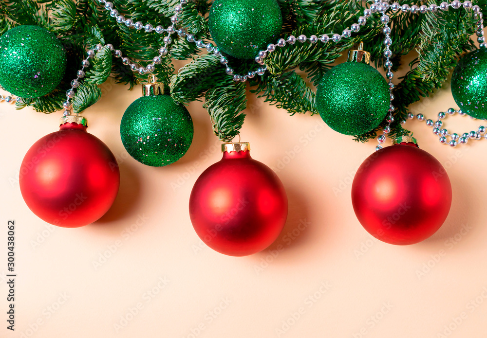 Red and green christmas balls with fir tree branches and silver beads decoration