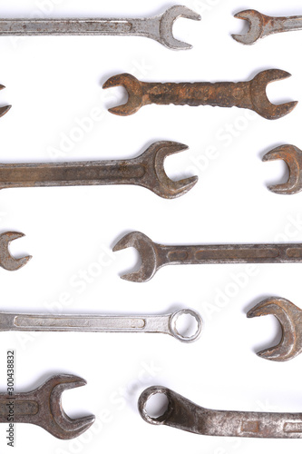 Old rusty stainless steel crescent wrench isolated on white top view