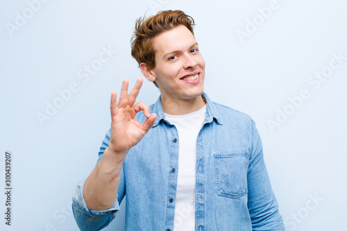 Fotografi young red head man feeling happy, relaxed and satisfied, showing approval with o