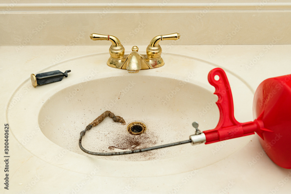 Plumbing Snake With Hair Clog In A Bathroom Sink Shallow Depth Of Field Stock Photo Adobe - How To Snake The Bathroom Sink