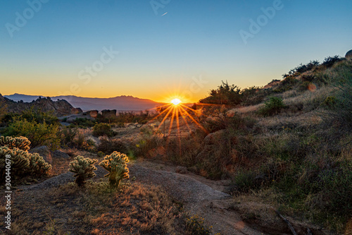 The sun rising in the desert photo