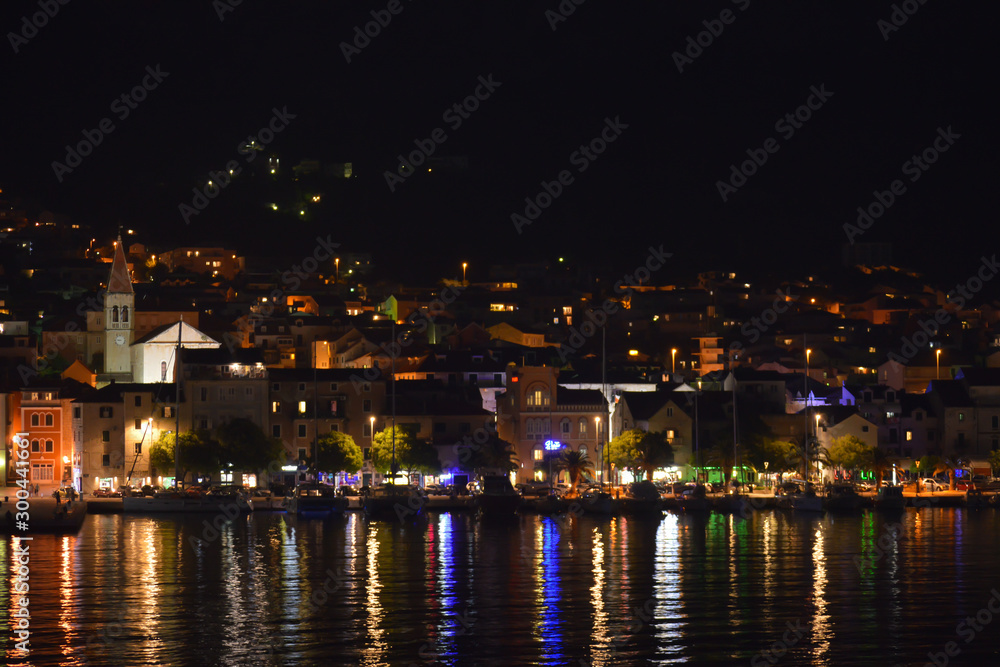 Panoramic night view of Makarska city center from the sea in Makarska, Croatia on June 16, 2019.