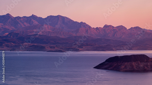 Morning light over Lake Meade with an island in the foreground and a mountain in that background. photo