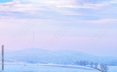 Sunset over hills covered with snow © tutye