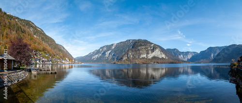 Panorma of famous Hallstatt. Hallstatt is located in the south of Upper Austria. The houses are built directly by Lake Hallstatt and the surrounding mountains. The scenery is reflecting in the lake.