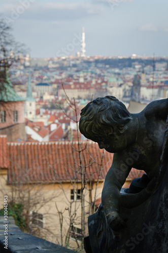 A sculpture dominating over the view of the ancient city of Prague , Czech Republic photo