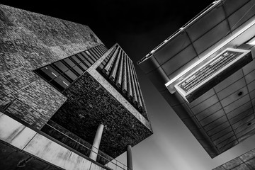 Low angle grayscale shot of brutalist architecture under the clear sky