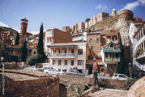01.06.2019 Tbilisi, Georgia: view of old stone houses with beautiful colored roofs in the center of the old town where tourists are walking