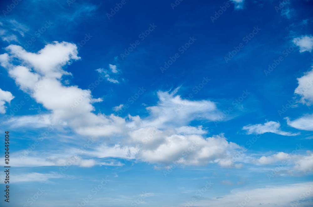 Blue sky background with white clouds. Blue sky and clouds. Beautiful cloud scape over horizon.