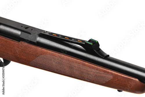 Modern bolt carbine isolated on white background. Close-up of a weapon with a wooden butt for hunting, sports and self-defense.