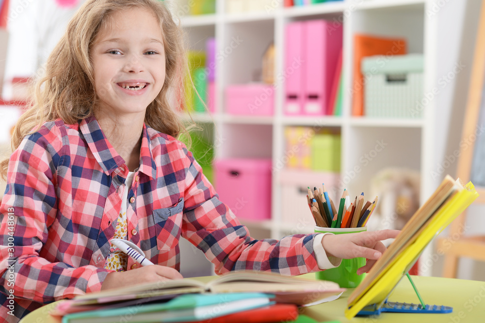 Cute teen girl doing homework in her room Cute teen girl doing homework in her room