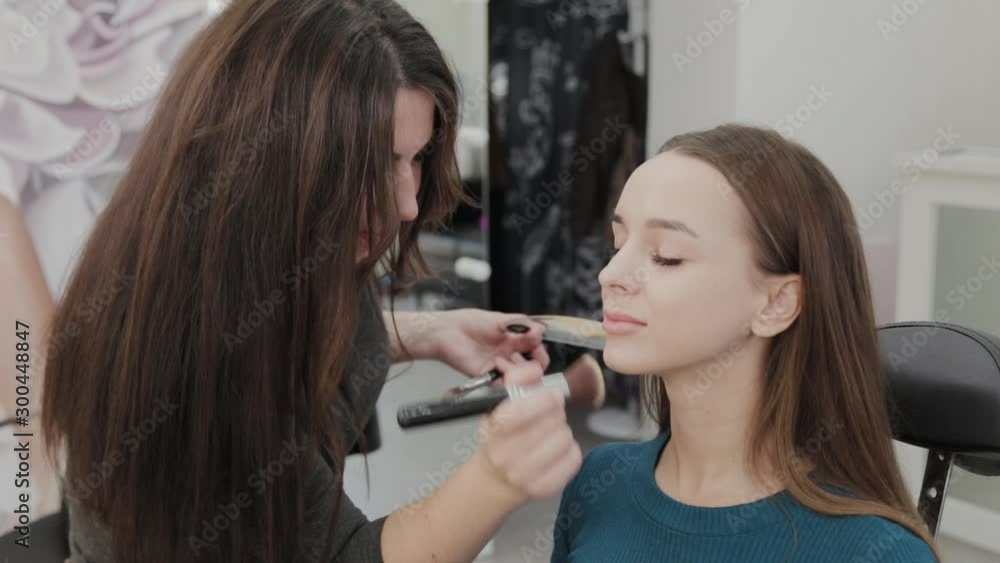 Professional makeup artist woman stirs makeup cream on a palette. Professional makeup artist woman stirs makeup cream on a palette.