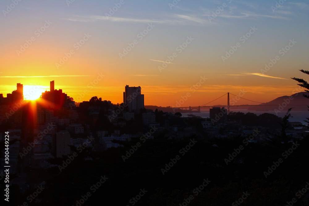 The sunset with the Golden Gate and the buildings