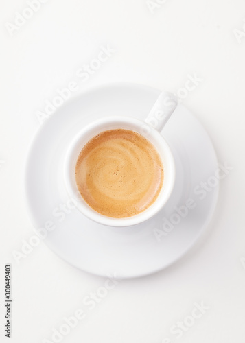 Cup of coffee isolated on white paper background. Top view. 