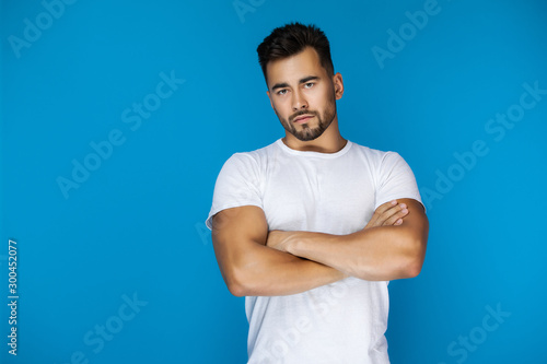 Sexy american man clasped his hands and seriously looks at the camera photo