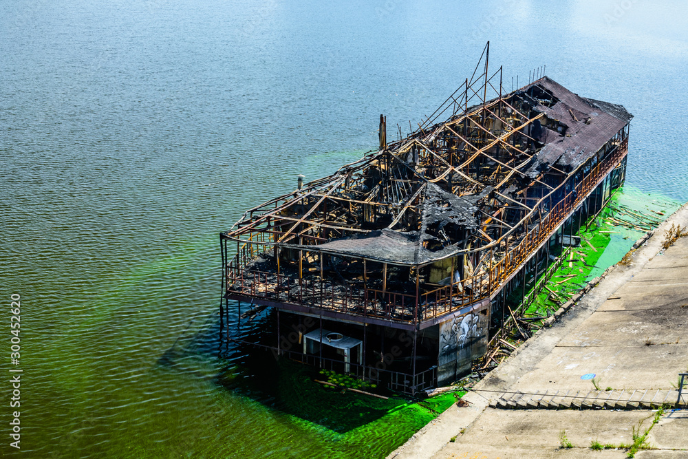 Old burnt cruise ship near the bank of river dnieper in Kiev, Ukraine Old burnt cruise ship near the bank of river dnieper in Kiev, Ukraine
