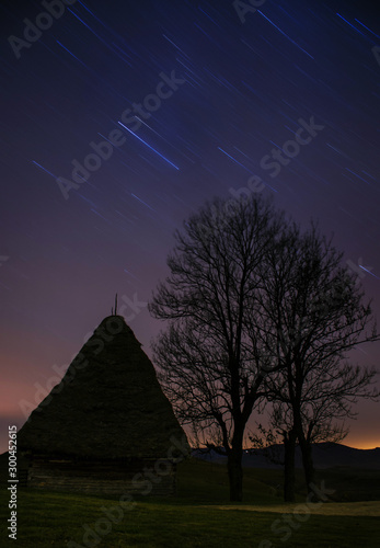 Star trails and traditional house in Dumesti village  Apuseni Mountains  Romania