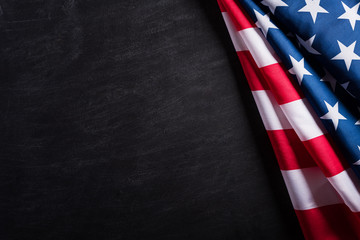Happy Veterans Day. American flags veterans against a blackboard background.