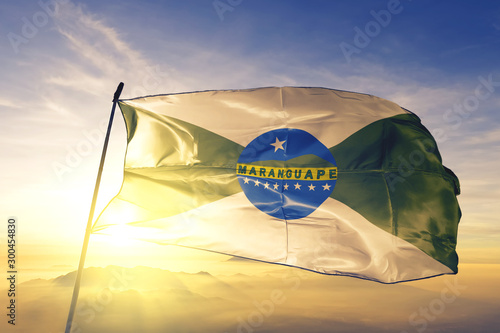 Maranguape of Brazil flag waving on the top sunrise mist fog photo
