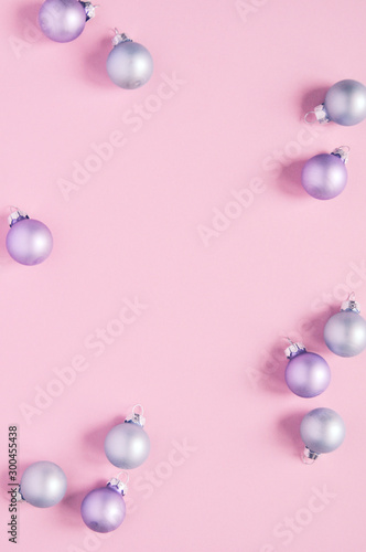 Christmas holiday background with decorations for the Christmas tree, balls of pastel colors on a delicate pink trend background.