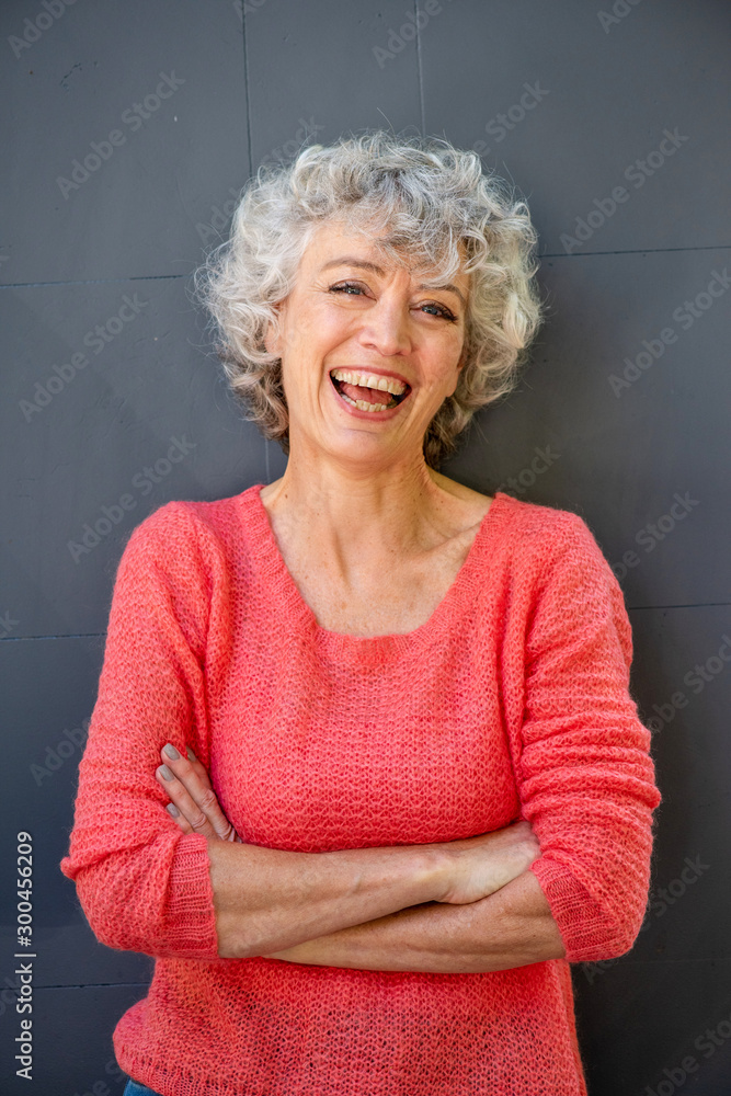 attractive middle aged woman laughing with arms crossed attractive middle aged woman laughing with arms crossed