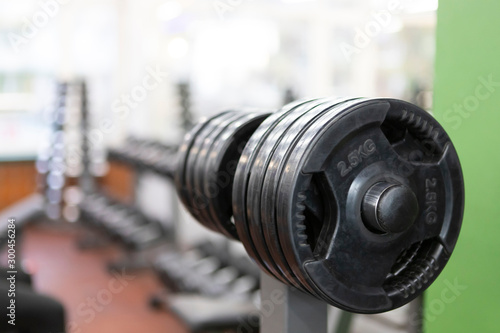 Barbell in Gym  sports inventory  with beautiful bokeh on bottom