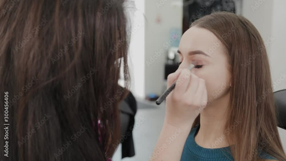 Professional makeup artist woman stirs makeup cream on a palette. Professional makeup artist woman stirs makeup cream on a palette.