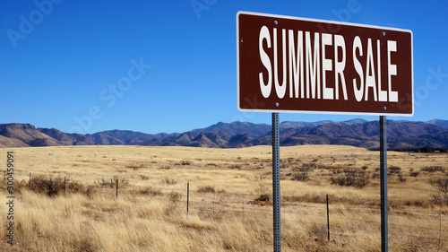 Summer sale word on road sign