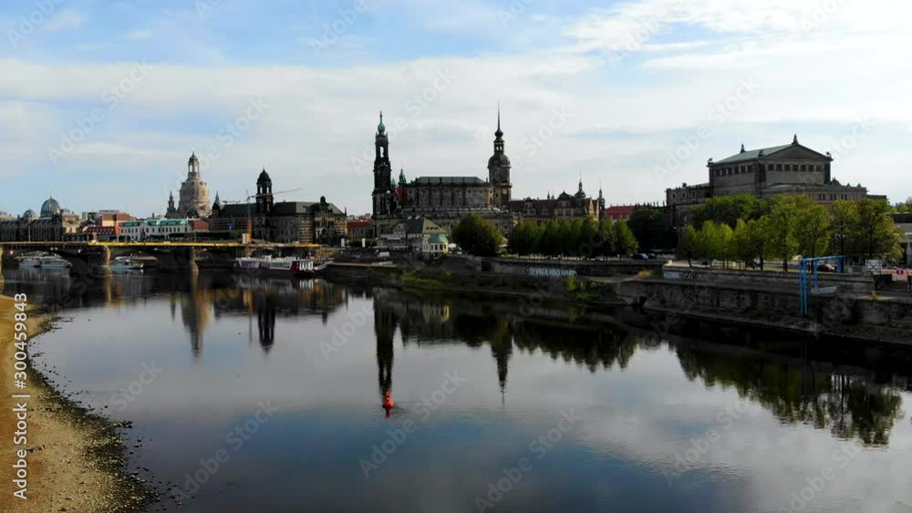 Aerial flying over River Elbe, view of the city center of Dresden, Germany. Famous Baroque-style architecture buildings are reflected in the water. Aerial shot taken by drone Aerial flying over River Elbe, view of the city center of Dresden, Germany. Famous Baroque-style architecture buildings are reflected in the water. Aerial shot taken by drone