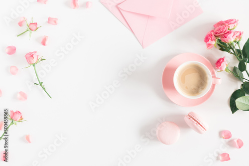 Flowers composition romantic. Flowers roses and rose petals, macaroon, cup coffee on white background. Happy women's day. Valentine's Day. Flat lay, top view