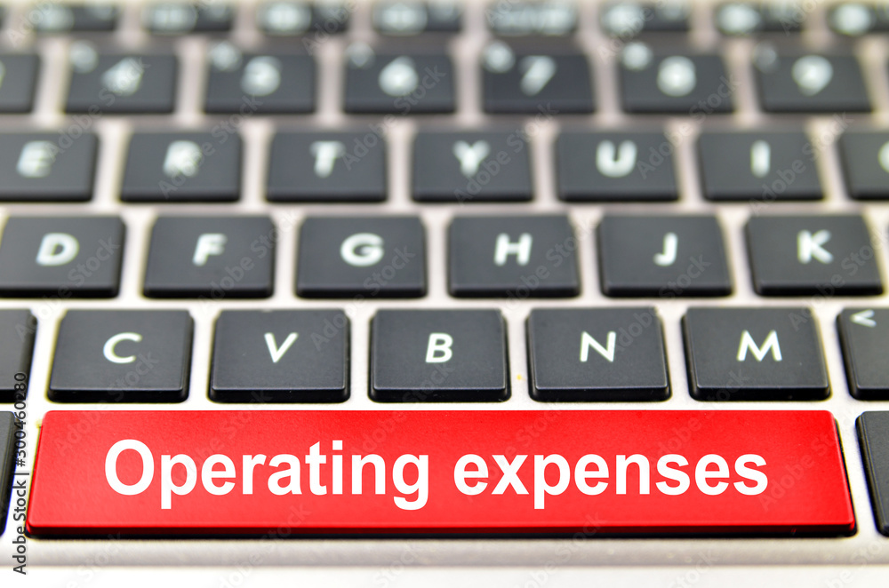 Operating expenses word on computer space bar Operating expenses word on computer space bar