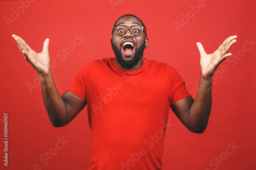 Portrait of excited young African American male screaming in shock and amazement. Surprised black hipster looking impressed, can't believe his own luck and success.